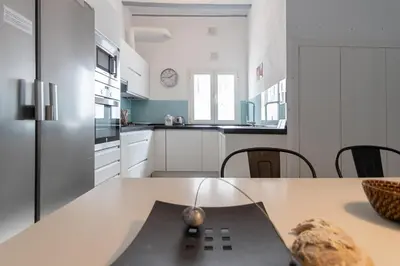 a kitchen with a table and chairs in a room at Apartamento Sweet Home in Cádiz in Cádiz