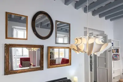 a group of mirrors on a white wall at Apartamento Sweet Home in Cádiz in Cádiz