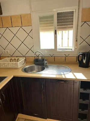 a kitchen counter with a sink and a window at Esencia de Arcos in Arcos de la Frontera