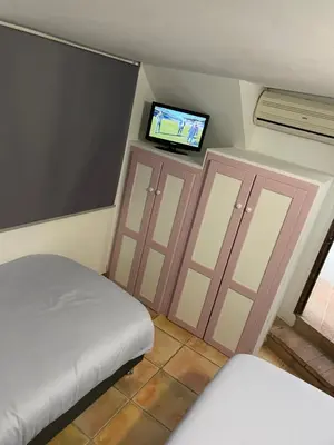 a bedroom with a bed and a flat screen tv at Esencia de Arcos in Arcos de la Frontera
