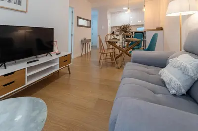 a living room with a couch and a flat screen tv at Apartamento El Bergantin de Cádiz in Cádiz