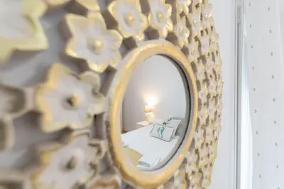 a mirror with a bed in a room at Apartamento El Bergantin de Cádiz in Cádiz