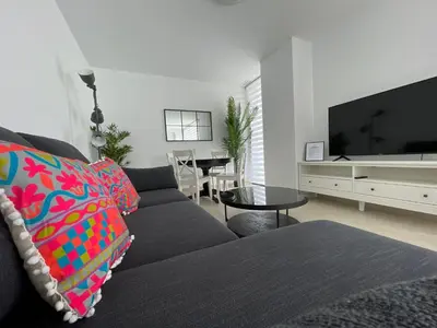 a living room with a couch and a tv at LHOME CÁDIZ in Cádiz