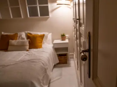 a bedroom with a white bed with yellow pillows at inncadizCasa Apolo in Cádiz