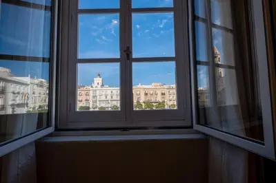 an open window with a view of a building at inncadizCasa Apolo in Cádiz