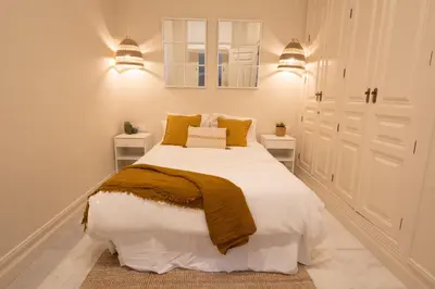 a bedroom with a large bed with two night stands at inncadizCasa Apolo in Cádiz