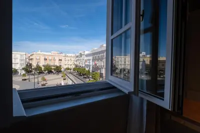 an open window with a view of a city street at inncadizCasa Apolo in Cádiz