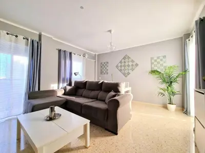 a living room with a couch and a table at Apartamento Alférez in Sanlúcar de Barrameda