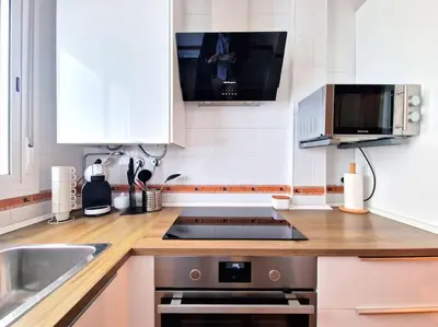 a kitchen with a sink and a stove top oven at Apartamento Alférez in Sanlúcar de Barrameda