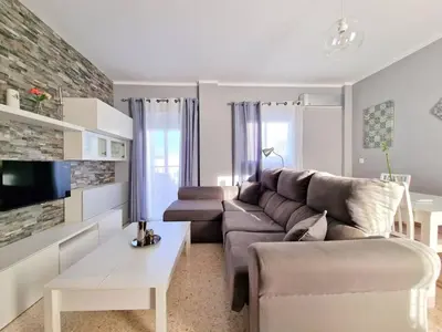 a living room with a couch and a table at Apartamento Alférez in Sanlúcar de Barrameda