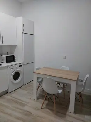 a kitchen with a table and chairs and a microwave at Luna Alameda Grupo AC Gestion in Cádiz