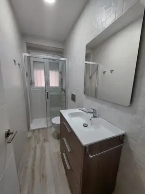a bathroom with a sink and a toilet and a mirror at Luna Alameda Grupo AC Gestion in Cádiz