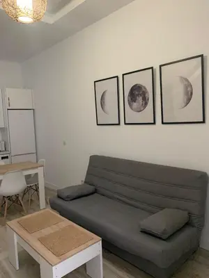 a living room with a couch and three pictures on the wall at Luna Alameda Grupo AC Gestion in Cádiz