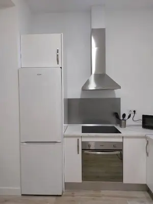 a white kitchen with a refrigerator and a stove at Sol Alameda Grupo AC Gestion in Cádiz