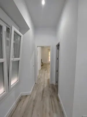 an empty hallway with white walls and wood floors at Sol Alameda Grupo AC Gestion in Cádiz