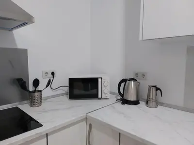 a kitchen with a microwave and a counter top at Sol Alameda Grupo AC Gestion in Cádiz