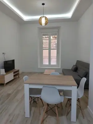 a white living room with a table and chairs at Sol Alameda Grupo AC Gestion in Cádiz