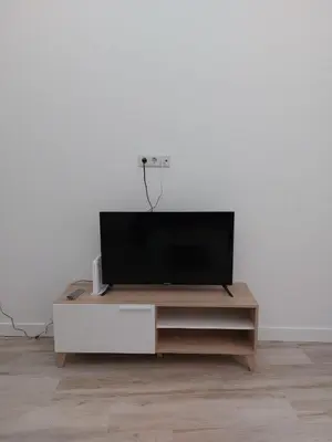 a flat screen tv sitting on top of a wooden entertainment center at Sol Alameda Grupo AC Gestion in Cádiz