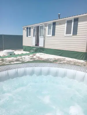 a large pool of water in front of a house at Tiny house Chill escape para 7 - private Jacussy Brisa & Burbujas in Chiclana de la Frontera