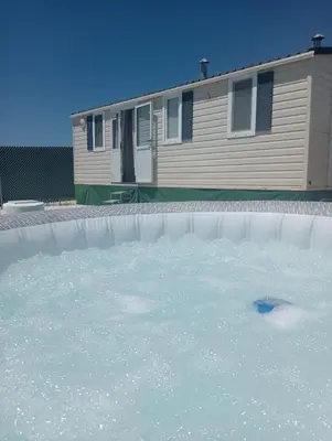 a pool of water in front of a house at Tiny house Chill escape para 7 - private Jacussy Brisa & Burbujas in Chiclana de la Frontera