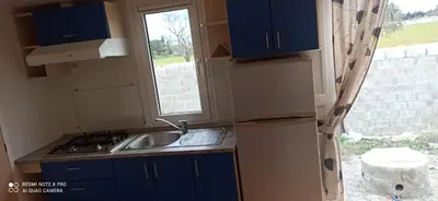 a kitchen with a sink and a stove and a window at Tiny house Chill escape para 7 - private Jacussy Brisa & Burbujas in Chiclana de la Frontera