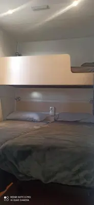 a bed in a room with a large bed at Tiny house Chill escape para 7 - private Jacussy Brisa & Burbujas in Chiclana de la Frontera