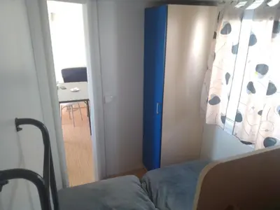a bedroom with a bed and a room with a table at Tiny house Chill escape para 7 - private Jacussy Brisa & Burbujas in Chiclana de la Frontera