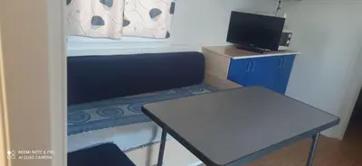a small room with a table and a desk with a television at Tiny house Chill escape para 7 - private Jacussy Brisa & Burbujas in Chiclana de la Frontera