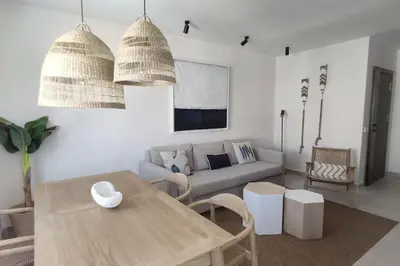 a living room with a couch and a table at Piso reformado de diseño c/terraza. Playa el Ancla in El Puerto de Santa María