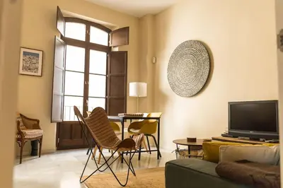 a living room with a couch and a tv at Candié by Gades Gestión in Cádiz