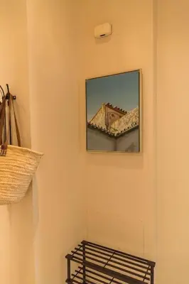 a room with a mirror on a wall with a shelf at Candié by Gades Gestión in Cádiz