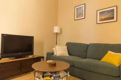 a living room with a couch and a tv at Candié by Gades Gestión in Cádiz