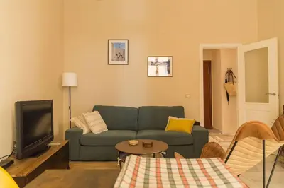 a living room with a couch and a tv at Candié by Gades Gestión in Cádiz