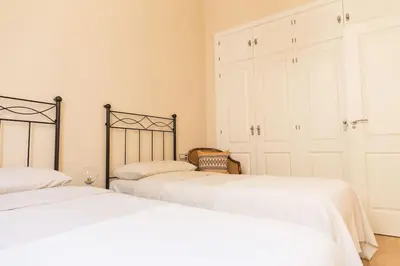 two beds sitting next to each other in a bedroom at Candié by Gades Gestión in Cádiz