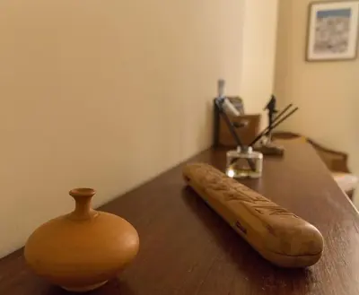 a wooden table with a vase on top of it at Candié by Gades Gestión in Cádiz
