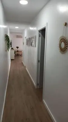 a hallway with a hallway leading to a room with white walls at Acogedor piso centro, San Miguel in Jerez de la Frontera
