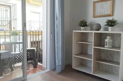 a room with a sliding glass door with a window at Acogedor piso centro, San Miguel in Jerez de la Frontera
