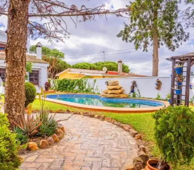 a home with a swimming pool in a yard at Gran Casa con Piscina Privada by Chiclana Dreams in Chiclana de la Frontera