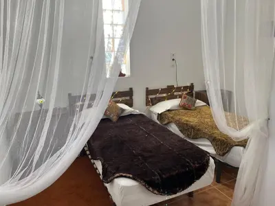 a bedroom with two beds with mosquito nets at CÁDIZ - BUDA, acogedor apartamento en Chiclana de la Frontera, España in Chiclana de la Frontera