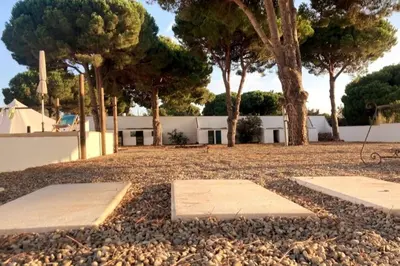 a park with trees and a white building at CÁDIZ - BUDA, acogedor apartamento en Chiclana de la Frontera, España in Chiclana de la Frontera