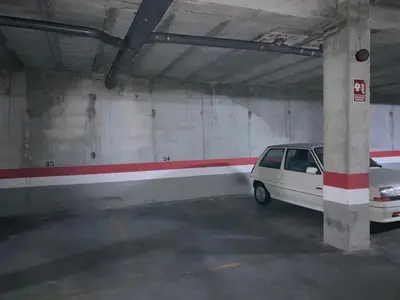 a white car parked in a parking garage at APARTAMENTO LOS ALTOS DE EL PUERTO - Calidad, Garaje y WiFi in El Puerto de Santa María