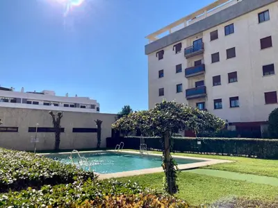 a swimming pool in front of a building at APARTAMENTO LOS ALTOS DE EL PUERTO - Calidad, Garaje y WiFi in El Puerto de Santa María