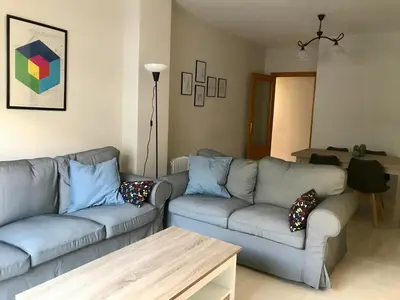 a living room with a couch and a table at APARTAMENTO LOS ALTOS DE EL PUERTO - Calidad, Garaje y WiFi in El Puerto de Santa María