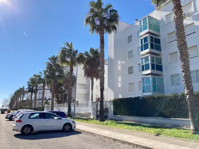 a white car parked in front of a building at ÁTICO VALDELAGRANA PLAYA - Aire Acondicionado y Piscina in El Puerto de Santa María