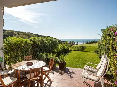 a patio with a table and chairs and the ocean at Villa Cristina by Interhome in Conil de la Frontera