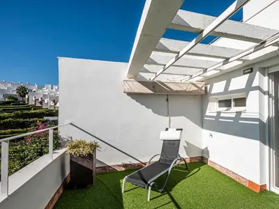 a chair on the balcony of a house at Villa Cristina by Interhome in Conil de la Frontera