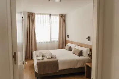 a bedroom with a large bed with a window at esZentrico Suites Jerez in Jerez de la Frontera