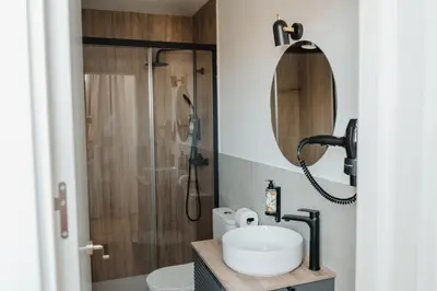 a bathroom with a sink and a shower at esZentrico Suites Jerez in Jerez de la Frontera
