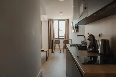 a kitchen with a sink and a counter top at esZentrico Suites Jerez in Jerez de la Frontera