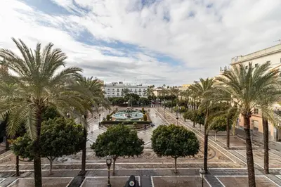 a city square with palm trees and buildings at Allo Apartments Plaza Arenal Centro 2 Habitaciones in Jerez de la Frontera